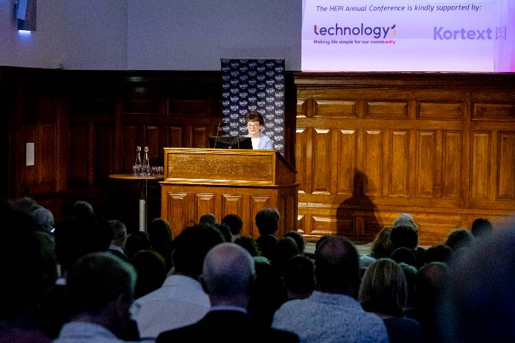 Professor Dame Sally Mapstone standing in front of a podium during a presentation