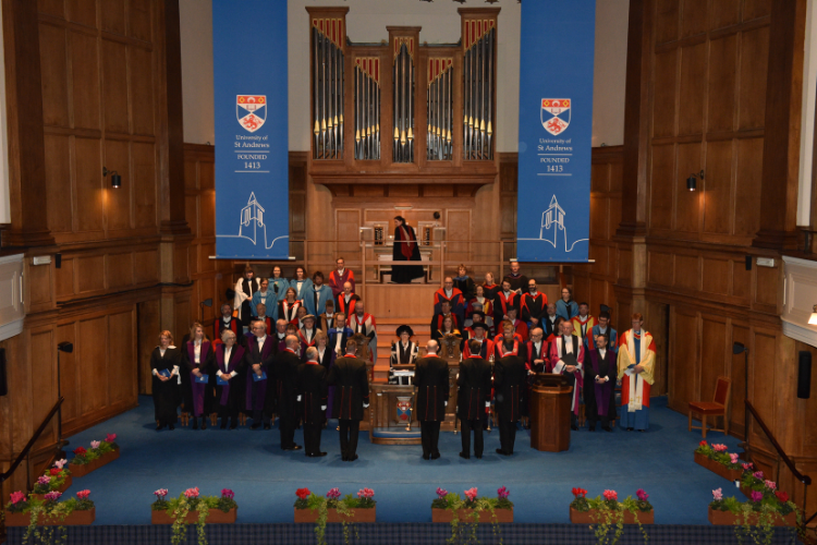 A graduation ceremony taking place on the stage in Younger Hall, St Andrews