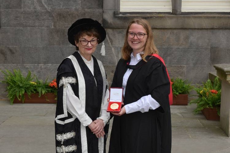 L S E Anderbjork receiving the Principal's Medal from Professor Dame Sally Mapstone