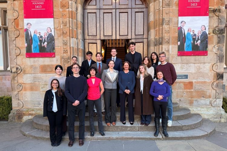 University of St Andrews students and Chancellor standing at the entrance of Schools 2 and 3 at St Salvator's Quadrangle