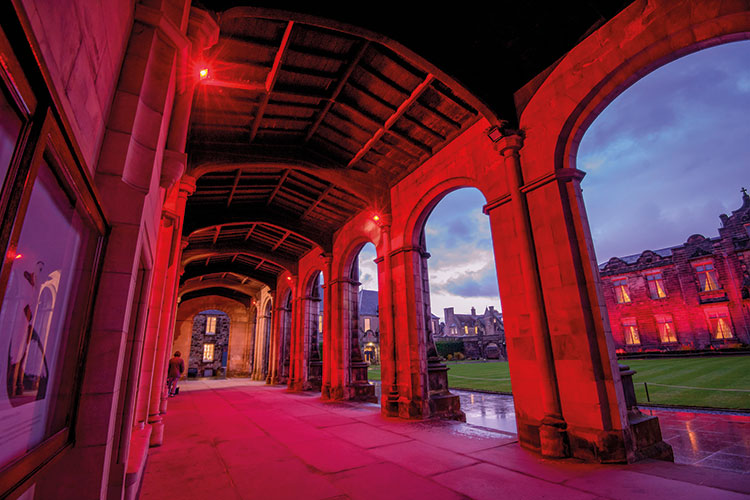 The cloisters of St Salvator's Quadrangle lit in red light