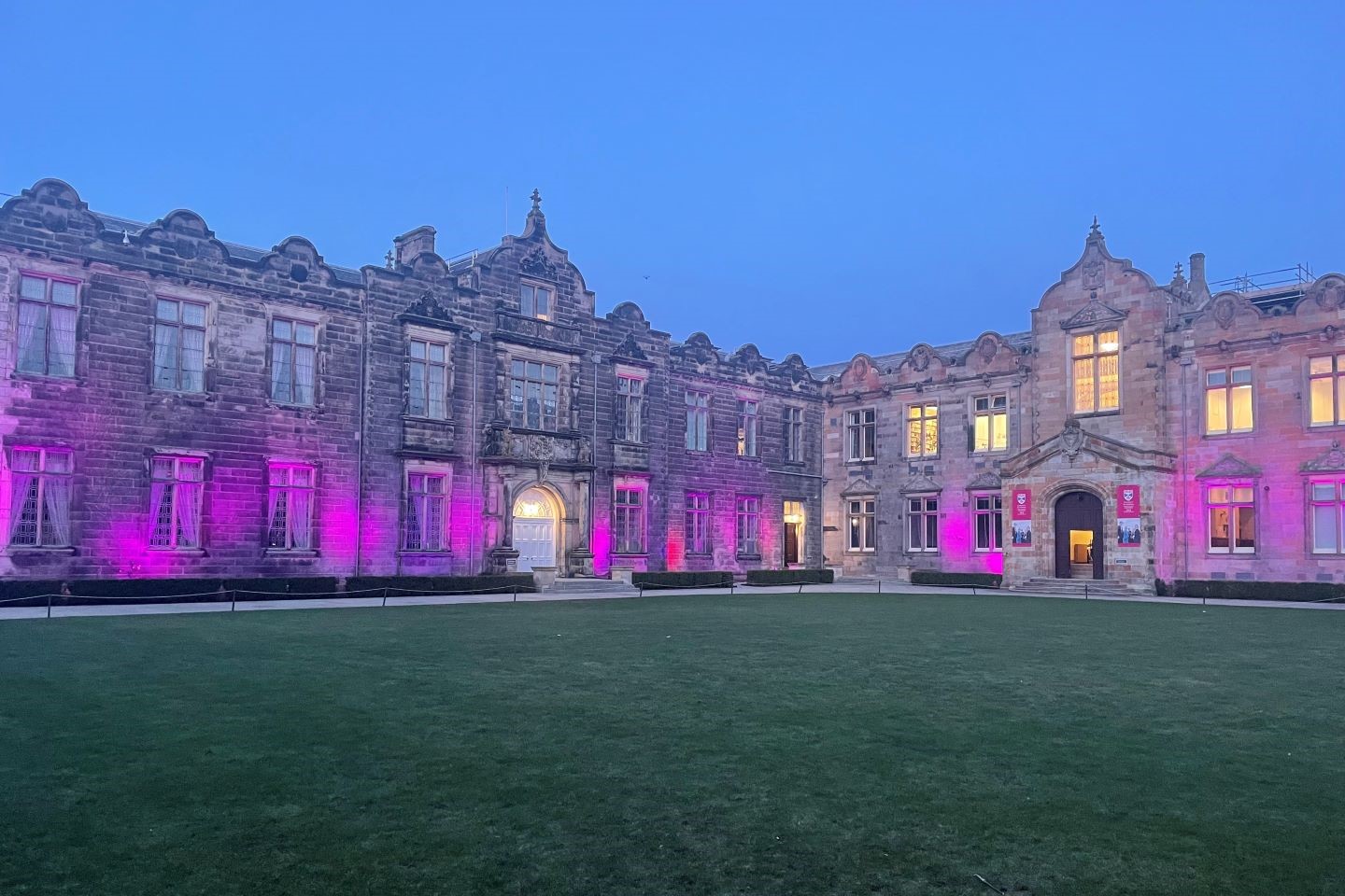 Exterior of Upper College Hall and quadrangle lawn with lights