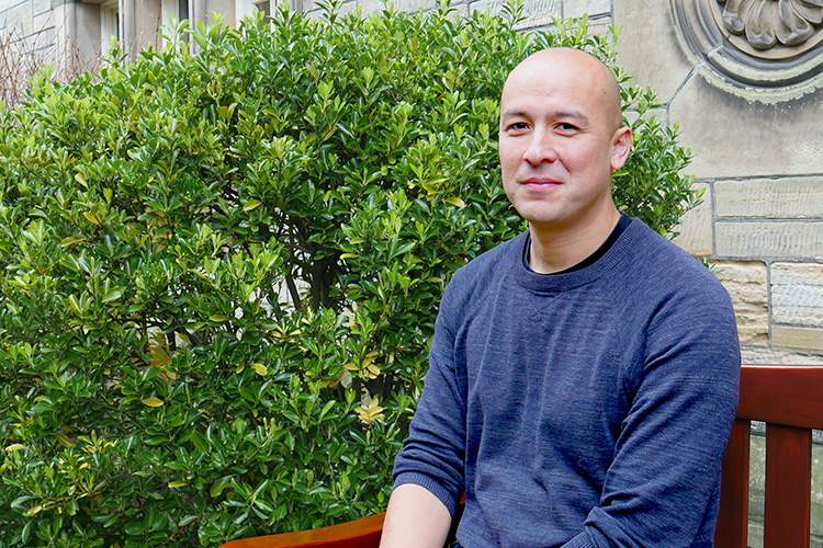man sitting on  bench