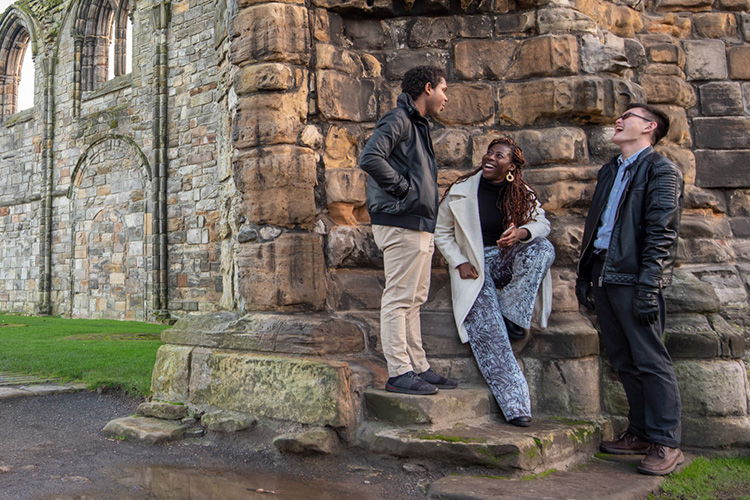 three students talking outside
