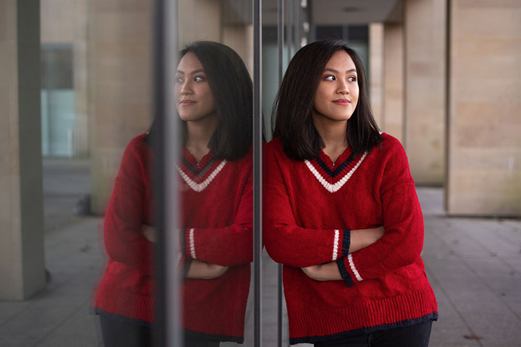 student leaning against window