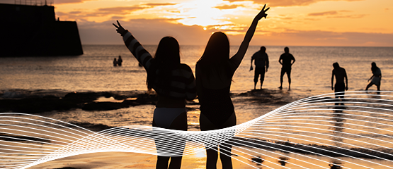 Students in the sea at sunrise