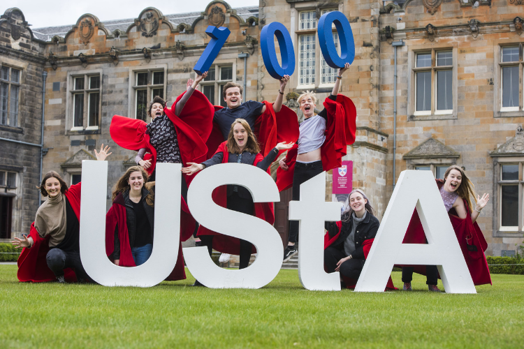 students in quad with UStA banner