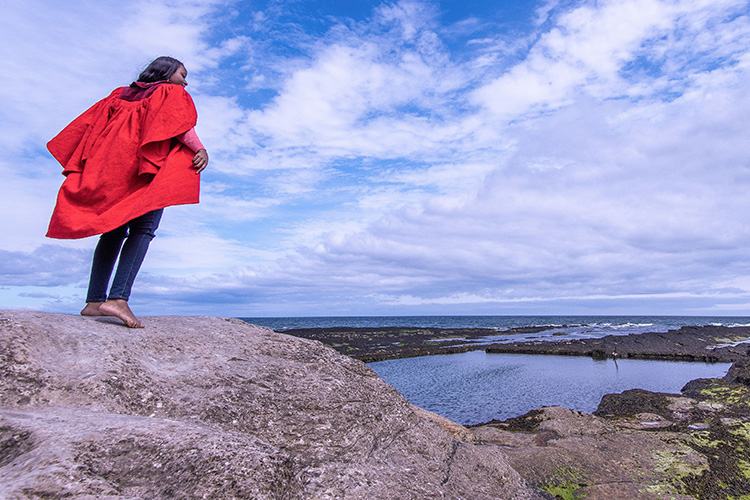 Student standing on rock