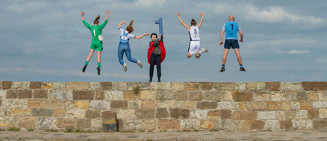 Students jumping on pier
