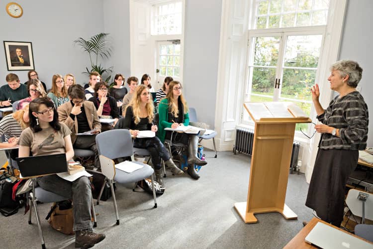 Students at desks in front of a lecturer