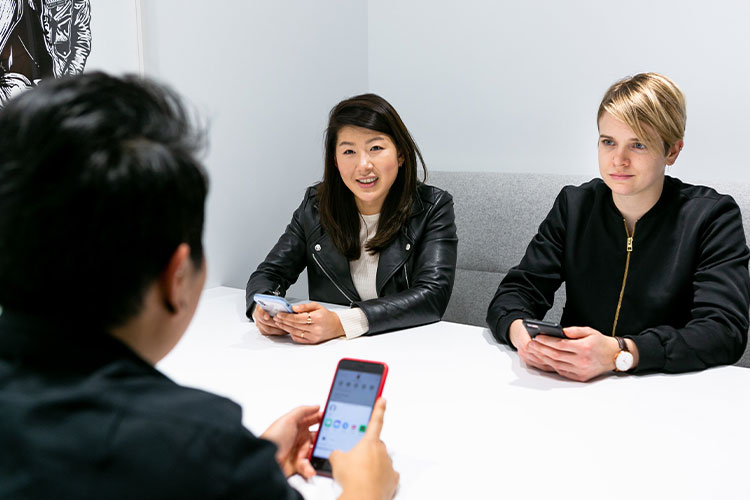 People sitting around a desk talking
