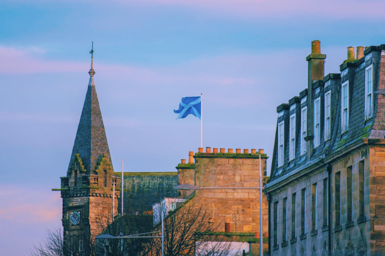 Picture of St Andrews rooftops, town hall and Scottish flag