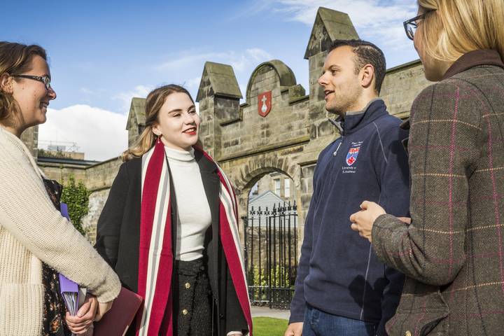 Four postgraduates talking to each other in St Salvator's Quad