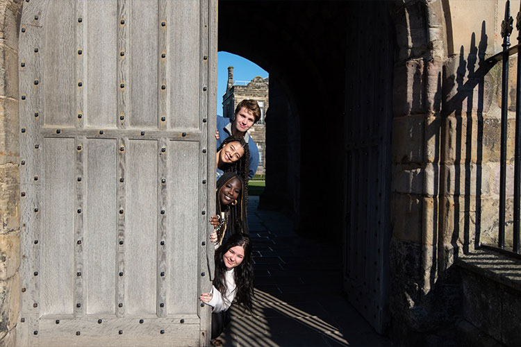 Students peering behind door at University of St Andrews