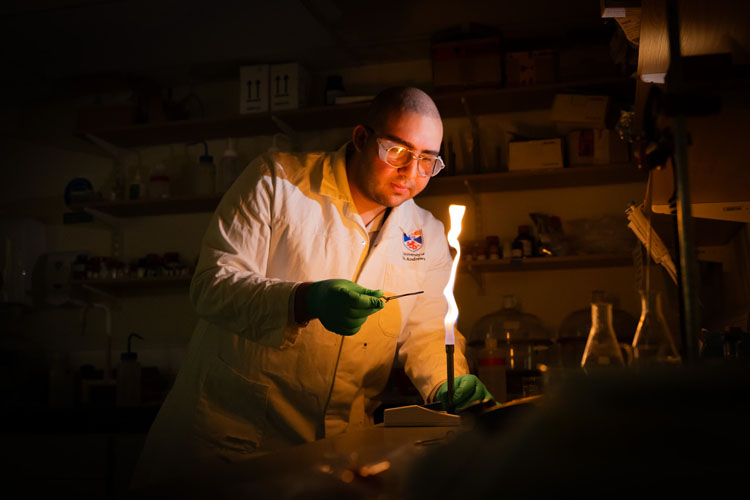 Scientist with a bunsen burner in the dark