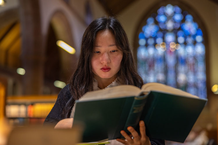 Close up of a student reading the the library