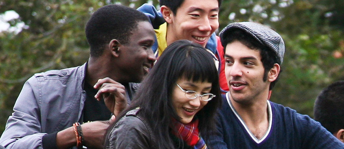 Four students from diverse backgrounds socialising