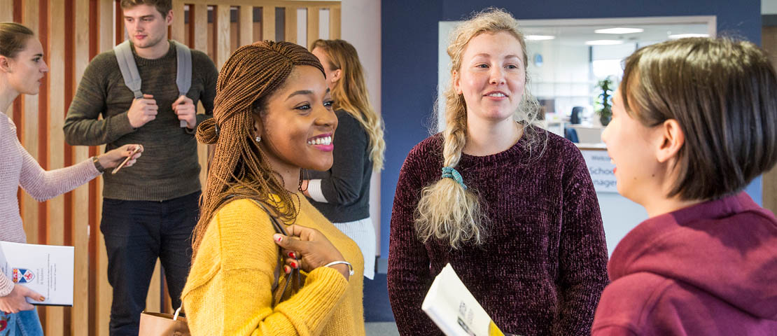 Male and female students socialising in the Gateway building