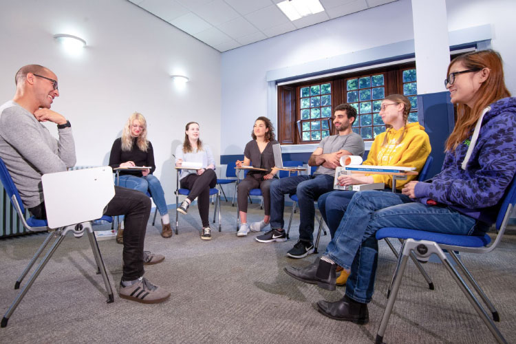 Small group of postgraduate students in an informal discussion setting