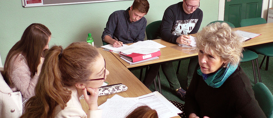 Teacher with a group of students in a classroom
