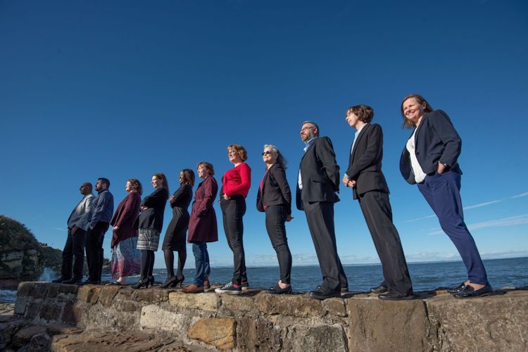 Team of people standing on the pier