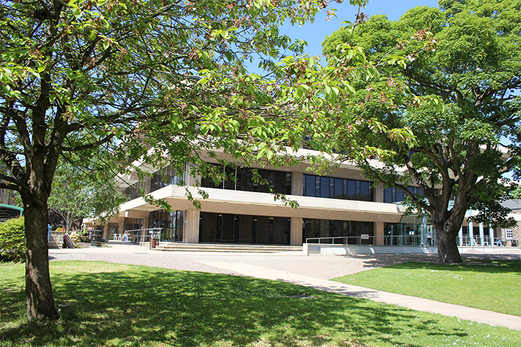 Outside main library with green trees and grass