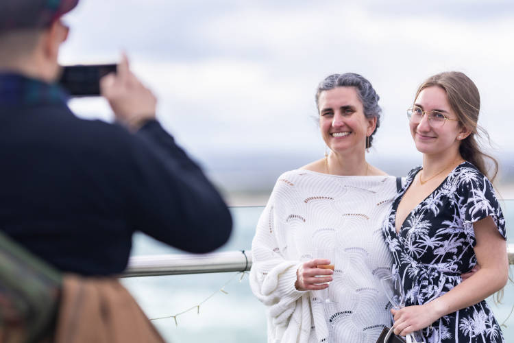 A photographer and two exhibition attendees on the viewing terrace at the Wardlaw Museum