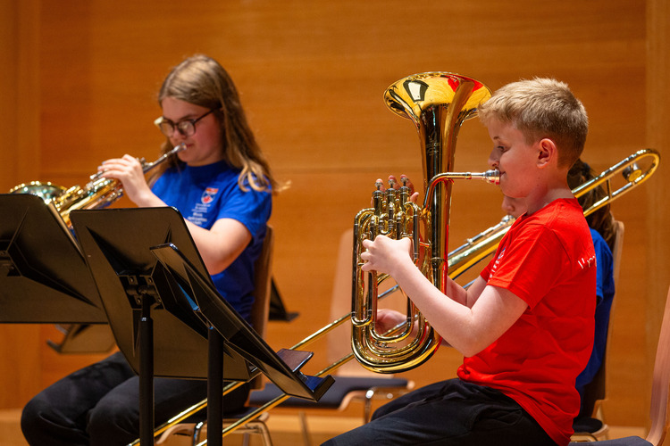 Two children playing musical instruments
