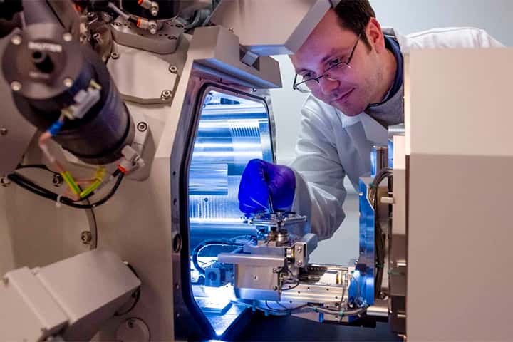 St Andrews researcher working with physics equipment