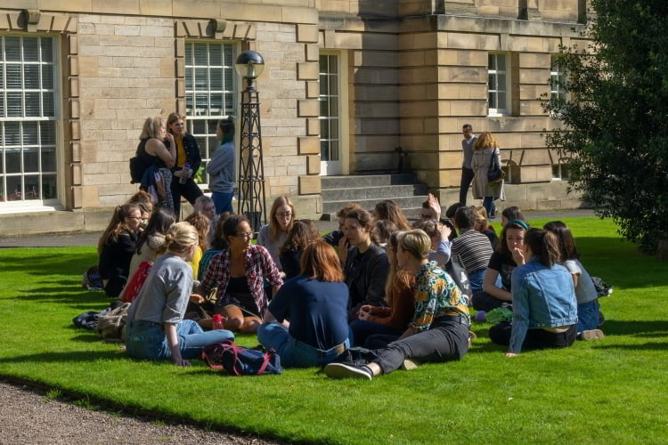 Photo of students resting on the lawn