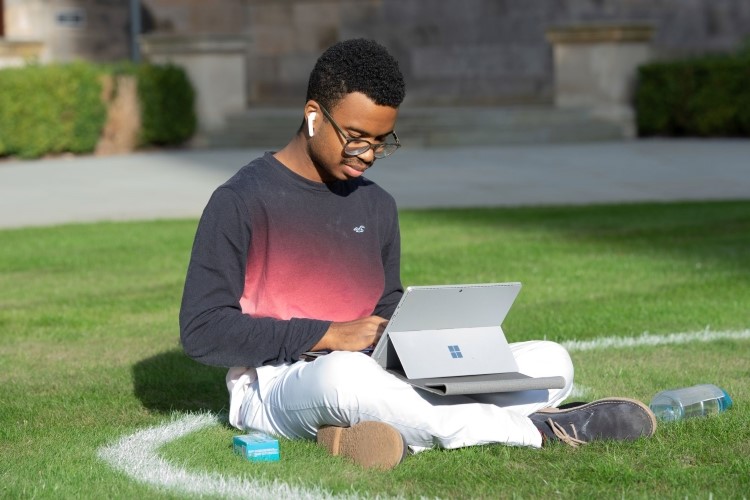 Postrgaduate student studying in the Quad