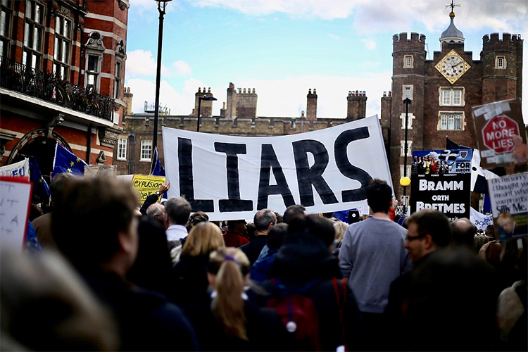 A banner at a demonstration reading