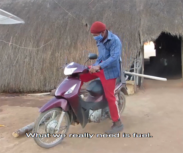 Wauja villager on motor scooter