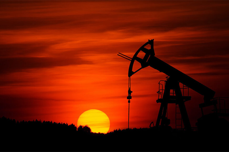 Oil rig against a red sky at sunset
