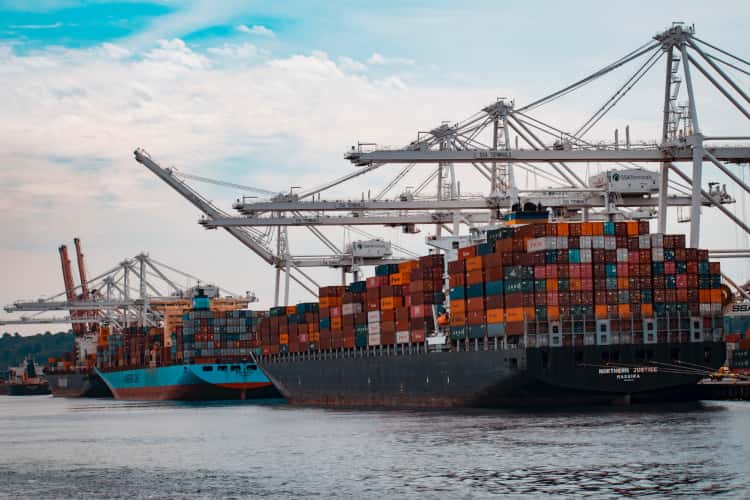 Two cargo ships sitting at dock