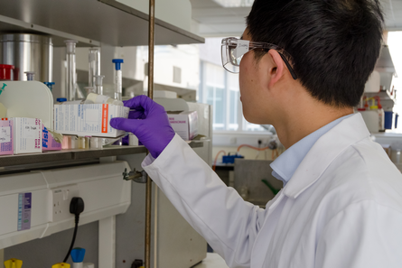 Student looking at chemical box