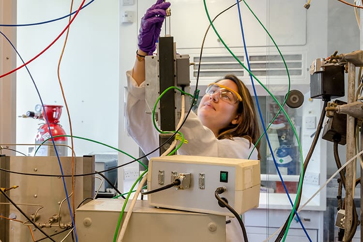 Researcher examines flask