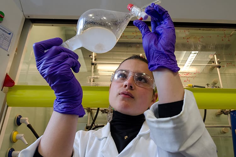 Scientist holding up bottle