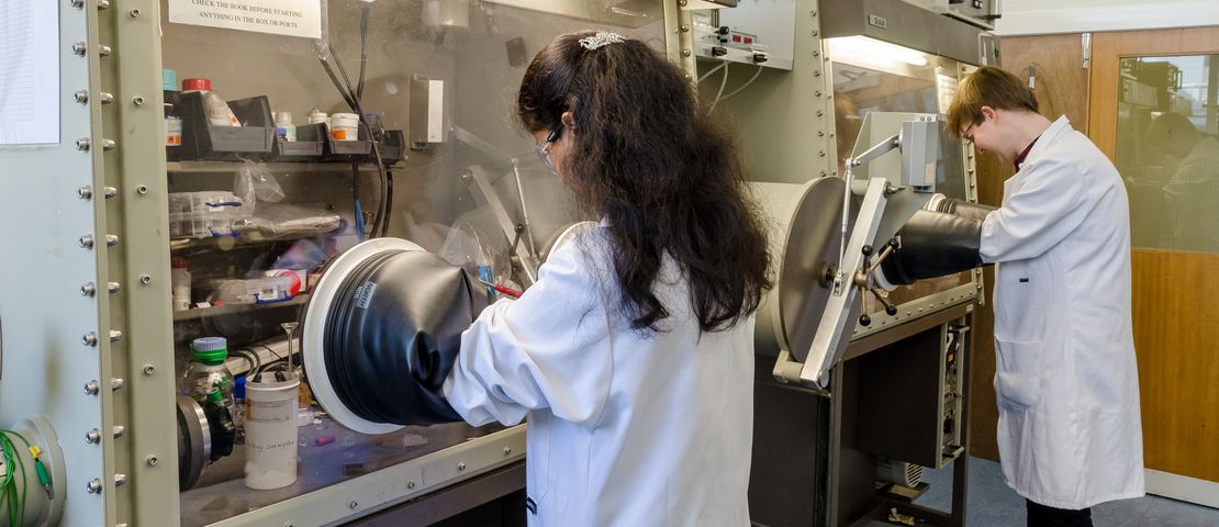 Chemists using gloveboxes