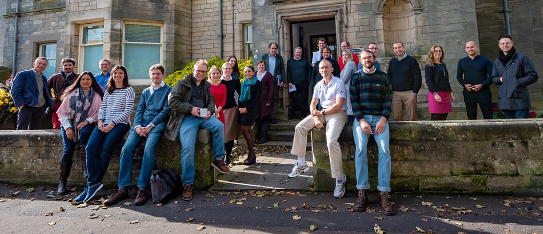 Classics staff standing in front of the School's building