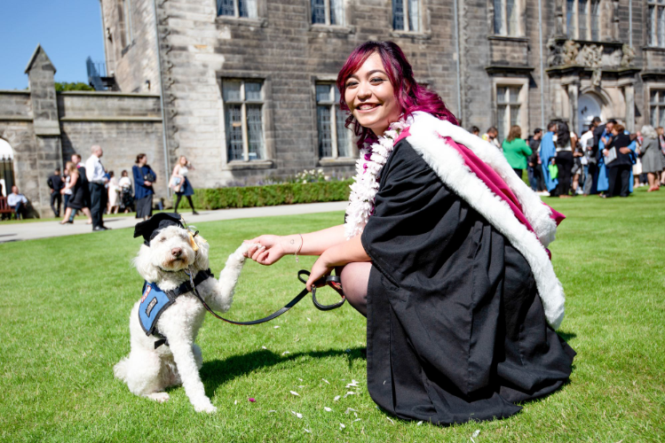 Graduating student with support dog