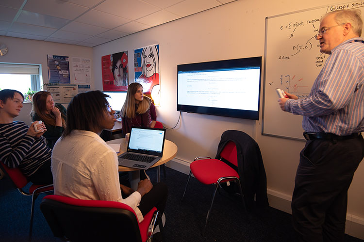 An academic teaching a small group of students