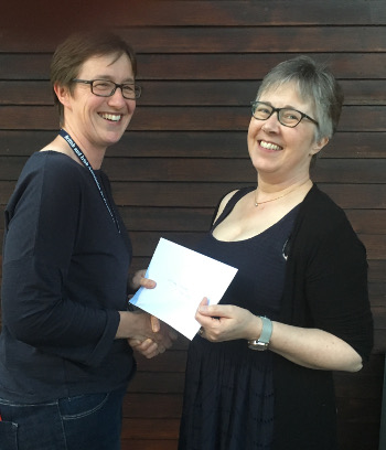 Diana Hall receiving her monetary prize from BIAPT chairperson