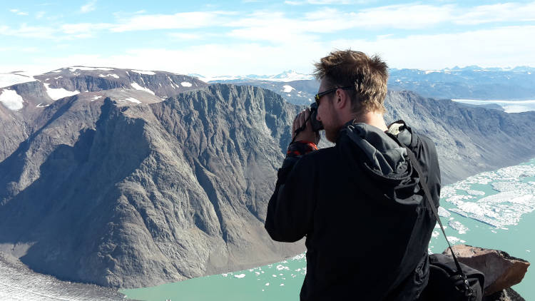 student photographing distant mountain range