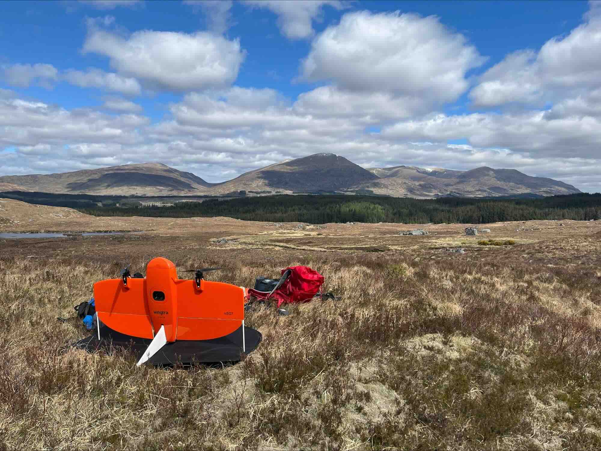 Wingtra fixed-wing drone within a montane landscape