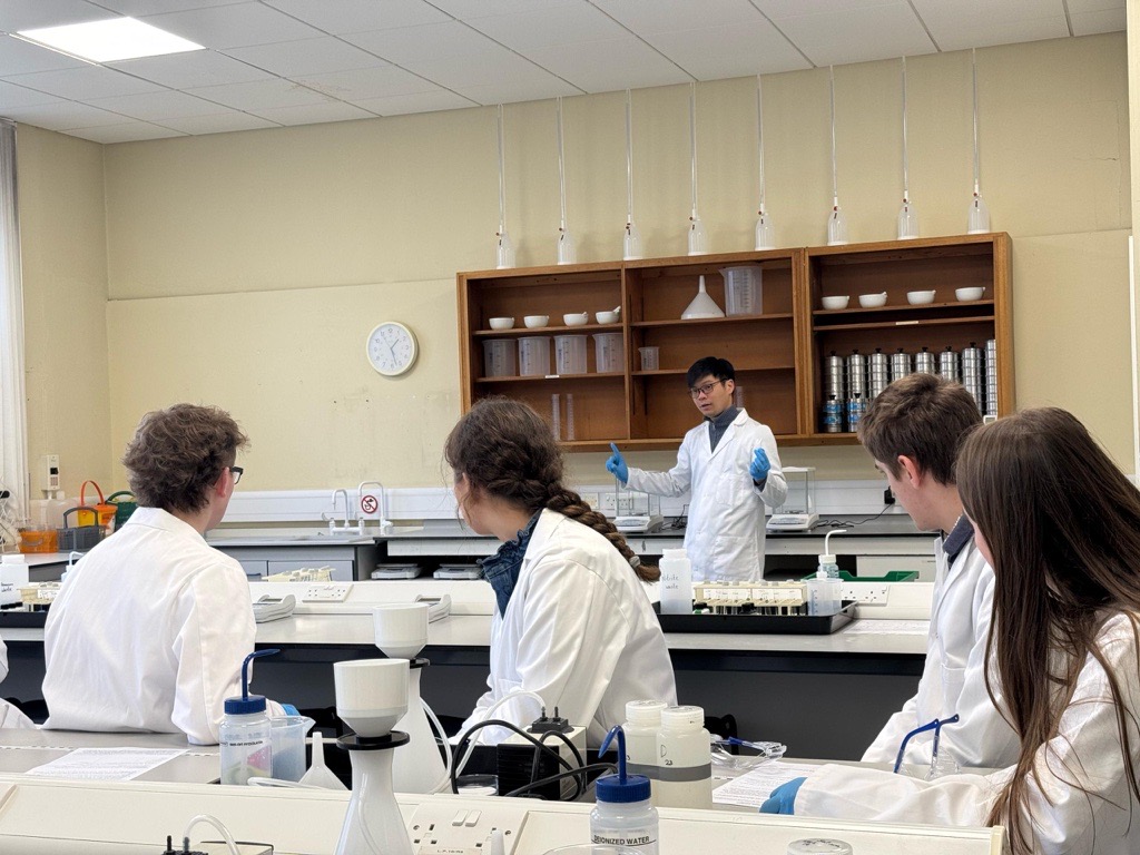 Lecturer demonstrating lab tasks to group of students