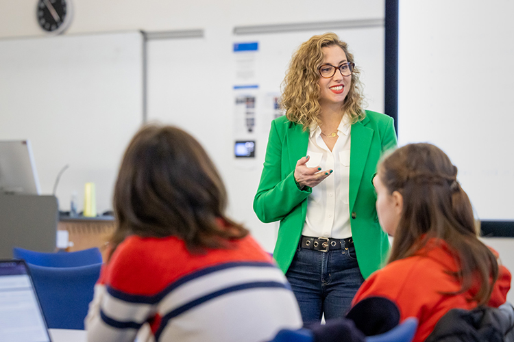 a lecturer speaking in front of two students