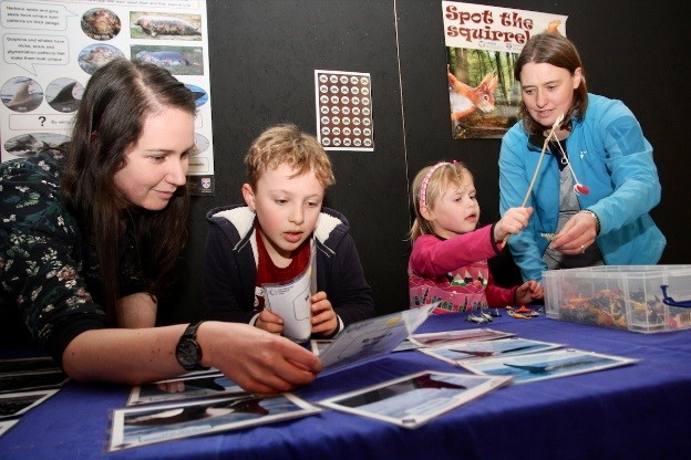 Children taking part in activities demonstrating the estimation abundance of wildlife populations