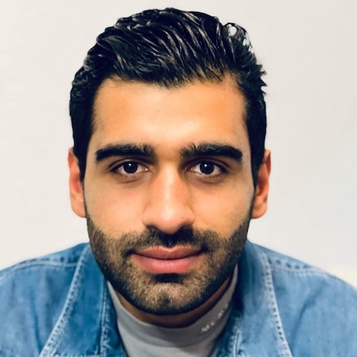 A passport style photo of a student smiling at the camera