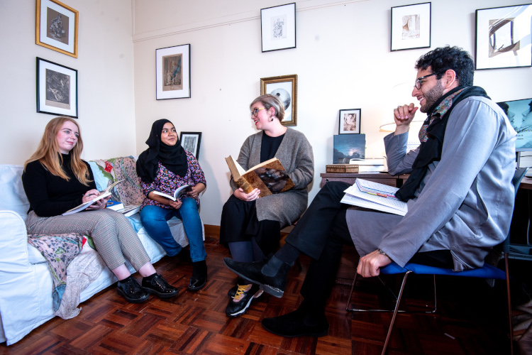 Lecturer with three students in tutorial